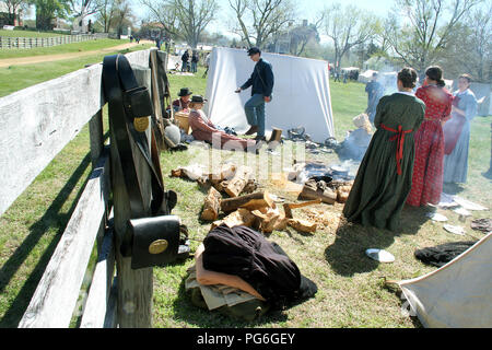 The Confederate Army camping during the American Civil War. Splitting wood and cooking over open fire. Historical reenactment at Appomattox, Virginia. Stock Photo