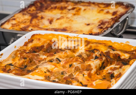 A vegetarian lasagne's just out the ovan and ready to cut. Focus set front to centre and softens towards rear of dish. Stock Photo