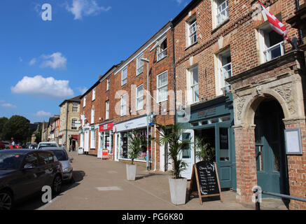 BRACKLEY, ENGLAND, 12 JULY 2018: Shops and businesses situated on the Market Place in Brackley. It is a town in Northamptonshire close to Silverstone 