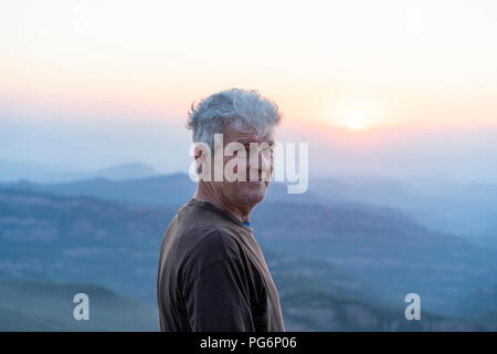 Spain, Catalonia, Man looking at sunset in the mountains Stock Photo