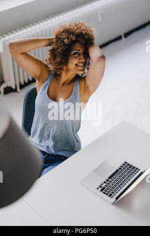 Woman working overtime in her start-up business Stock Photo