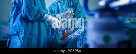 Knee surgery, Orthopedic Operation  - two surgeons performing a knee surgery on a patient (shallow DOF; color toned image) Stock Photo