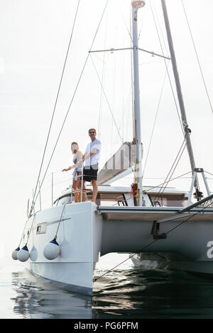 Mature couple making holidays, sailing on a catamaran Stock Photo