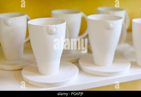 Mugs on shelf in porcelain workshop Stock Photo