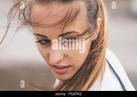 Portrait of sportive young woman outdoors turning round Stock Photo