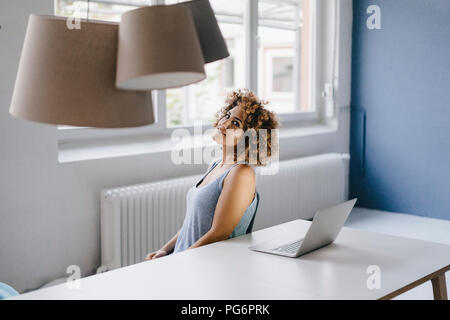 Woman working overtime in her start-up business Stock Photo