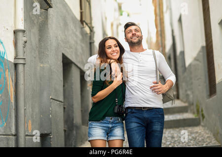 Happy tourist couple walking in the city Stock Photo