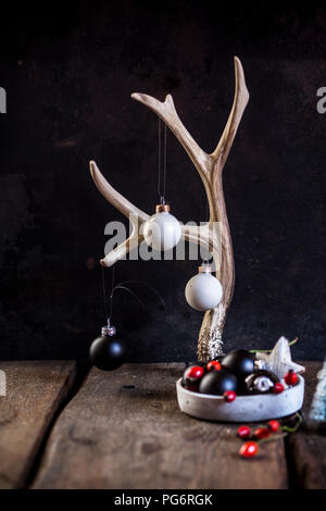 Christmas decoration with antler and  white and black baubles Stock Photo