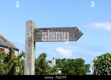 A wooden footpath finger post saying Coast Path , public footpath to Porthcurno 1/4 miles, Cornwall, England A wooden footpath finger post saying Coast Path , public footpath to Porthcurno 1/4 miles, Cornwall, England