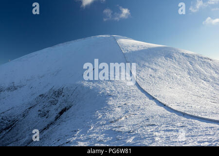 Upper slopes of Slieve Donard, N.Ireland's highest mountain, covered in snow in winter as viewed from The Saddle or col with Slieve Commedagh. Mournes Stock Photo