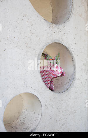 Origami rabbit sitting in hole Stock Photo