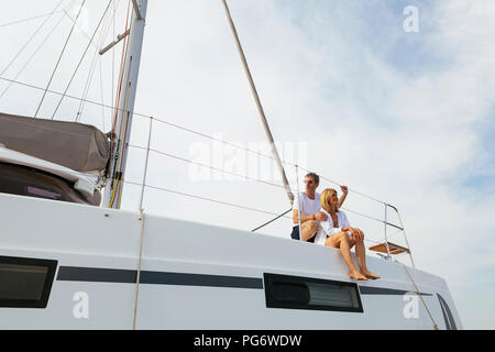 Mature couple making holidays, sailing on a catamaran Stock Photo