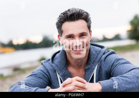 Portrait of smiling man at the riverside Stock Photo