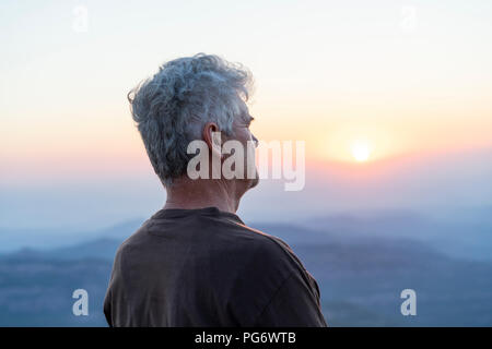 Spain, Catalonia, Man looking at sunset in the mountains Stock Photo