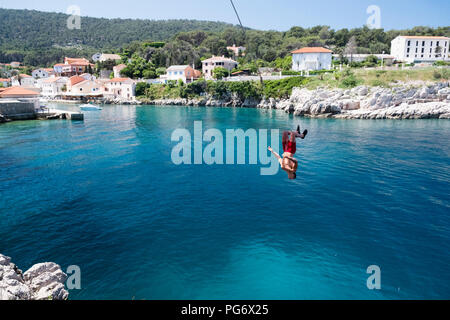 Croatia, Istria, Losinj, Rovenska, Young man bungee jumping Stock Photo