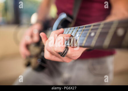 Close-up of man's hand playing electric guitar Stock Photo