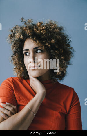 Portrait of a pensive woman with hand on chin Stock Photo