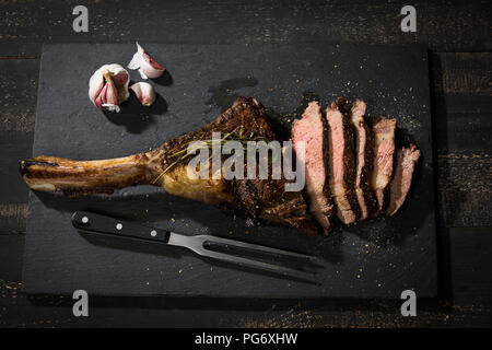 Grilled tomahawk steak and garlic Stock Photo