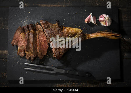 Grilled tomahawk steak and garlic Stock Photo