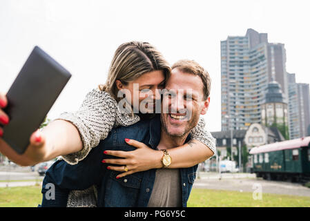 Happy couple taking a selfie in the city Stock Photo