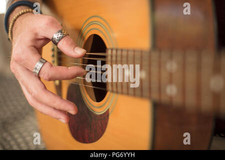 Close-up of man's hand playing guitar Stock Photo