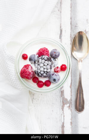 Glass of Greek yogurt with frozen berries Stock Photo