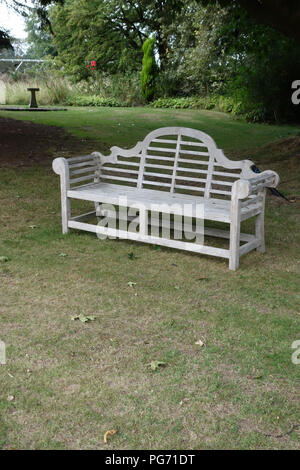 A traditionally shaped Lutyens 3 seater bench made from Cornis hardwood in a Large English country house in Nottinghamshire. Stock Photo