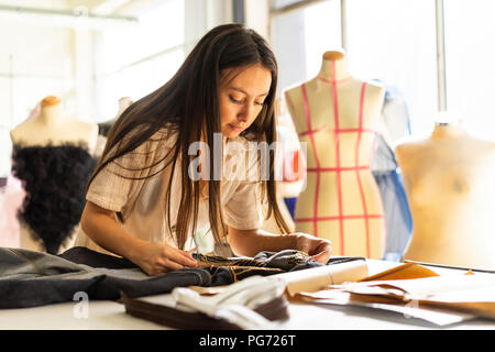 Young fashion designer working in her studio Stock Photo