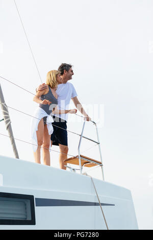 Mature couple making holidays, sailing on a catamaran Stock Photo