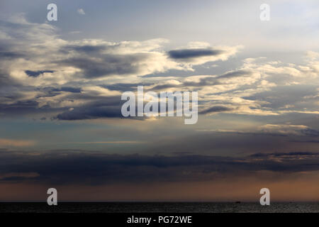 Beautiful and dramatic cloudscape at dusk with a sea horizon Stock Photo