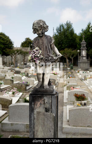 Old european cemetery weathered child statue Stock Photo