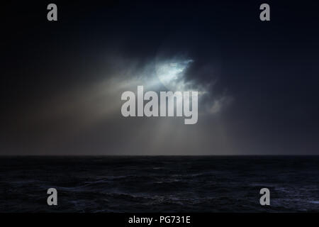 Dark overcast sea full moon night before storm. Used digital filter. Stock Photo