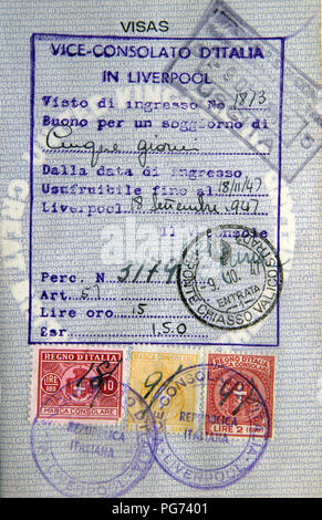 Old British blue passport page with entry visa stamps and an entry permission from the Italian Consulate in Liverpool. Stock Photo