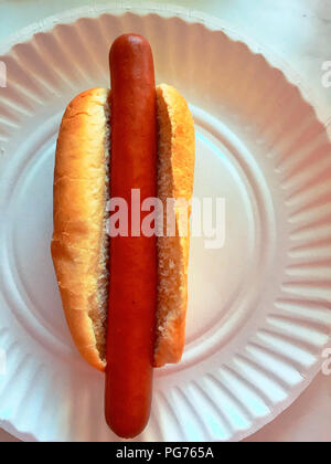 Plain hot dog in bun on paper plate Stock Photo