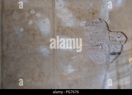 old brick wall  with peeling plaster - flat  renovation background  - Stock Photo