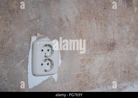 old electric plug socket closeup on vintage wall  - Stock Photo