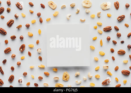 flat lay with various dried fruits and nuts with copy space in center isolated on white background Stock Photo