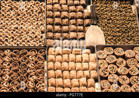 Turkish Baklava, filled with nuts, walnuts, pistaccios and almonds for sale on a market in the city center of Istanbul. It is one of the symbols of Tu Stock Photo