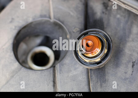 Oil filler for the car engine. Replenishing liquids in the drive unit. Place - car workshop. Stock Photo