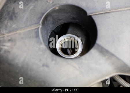 Oil filler for the car engine. Replenishing liquids in the drive unit. Place - car workshop. Stock Photo