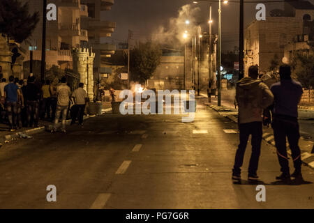Bethlehem, Palestine, July 23, 2014: Palestinians on the street in front of the separation wall in Bethlehem during night riots against Israel. Stock Photo