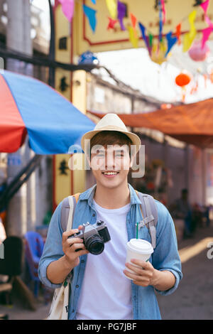 Young asian man traveler shopping walking on street market Stock Photo