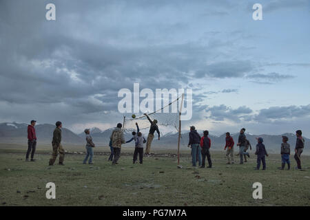 Volleyball game in front of the Great Pamir Range, Kara Jilga, Tajikistan Stock Photo