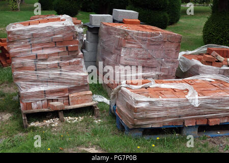 new reclaimed hand made red bricks on site Stock Photo