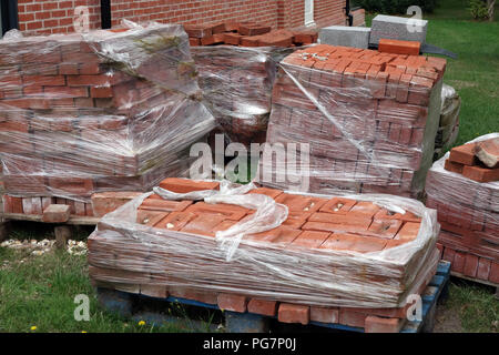 new reclaimed hand made red bricks on site Stock Photo