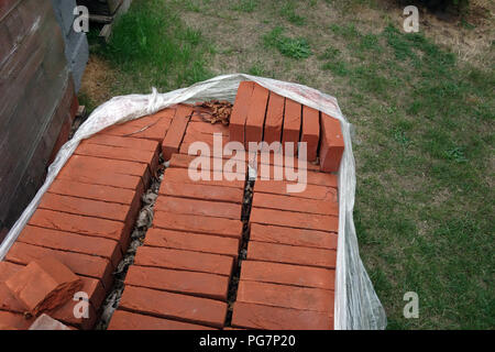 new reclaimed hand made red bricks on site Stock Photo