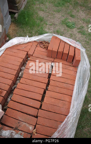 new reclaimed hand made red bricks on site Stock Photo