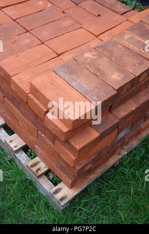 new reclaimed hand made red bricks on site Stock Photo