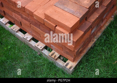 new reclaimed hand made red bricks on site Stock Photo
