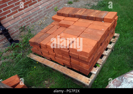 new reclaimed hand made red bricks on site Stock Photo